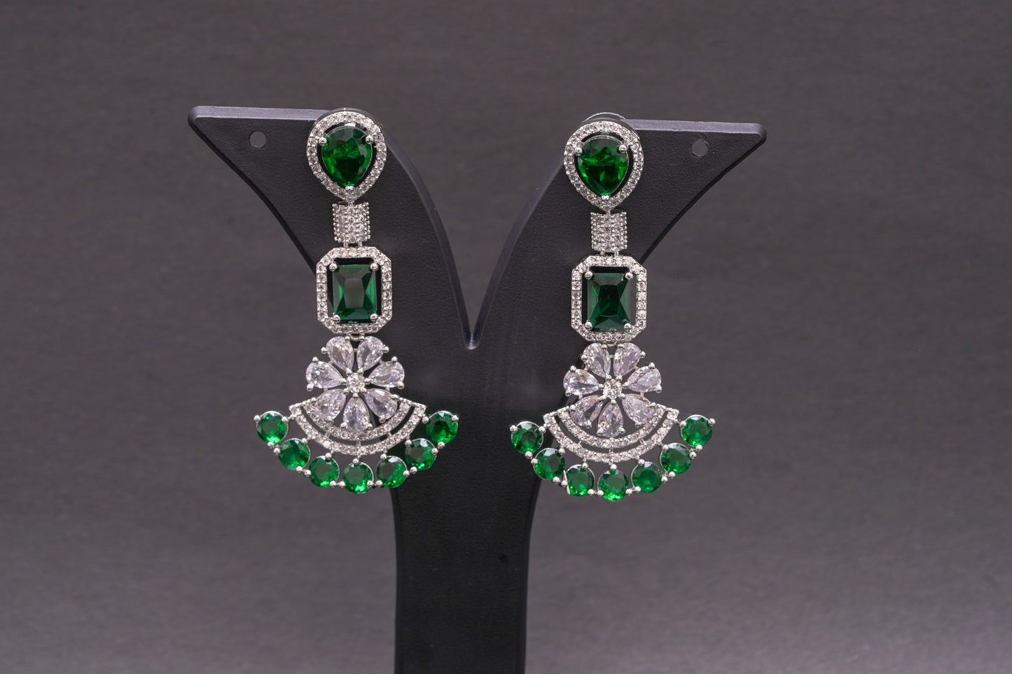 Chandelier earrings in real American diamonds and emerald green stones in a glittering finish