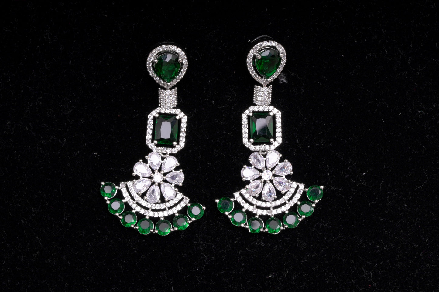 Chandelier earrings in real American diamonds and emerald green stones in a glittering finish