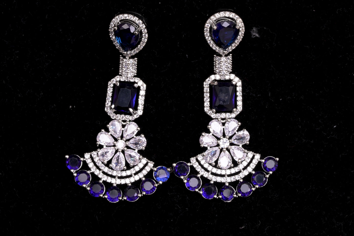 Chandelier earrings in real American diamonds and sapphire blue stones in a glittering finish
