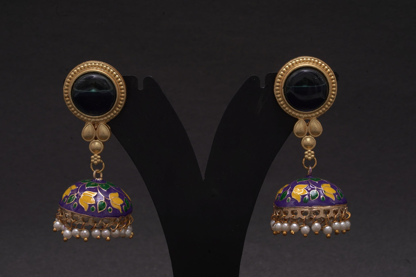 Colourful jhumkas in classic black with purple and white flowers with an enamel finish