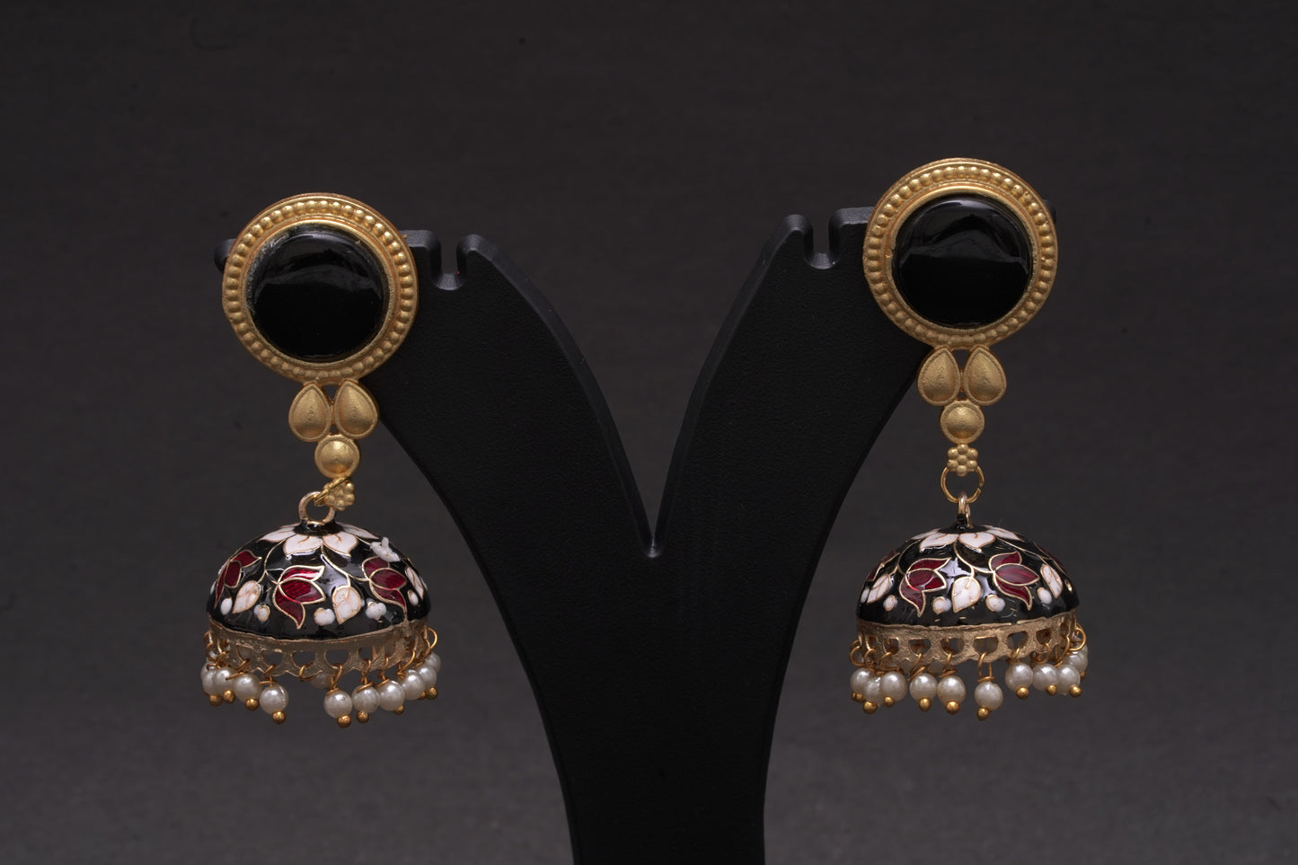Colourful jhumkas in classic black with white and red flowers with an enamel finish