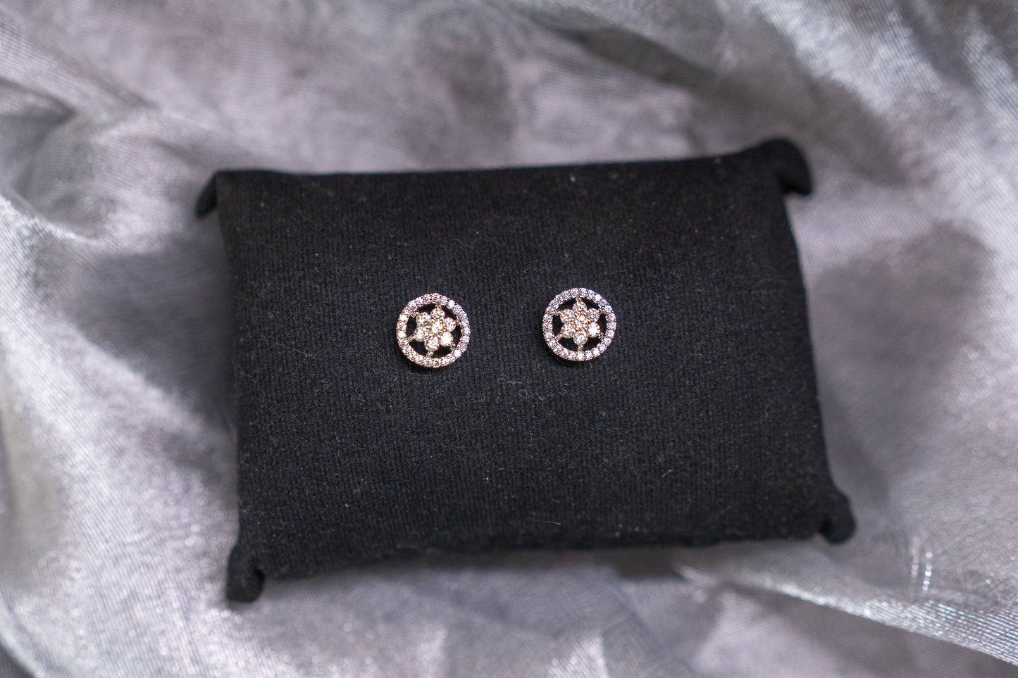 Delicate flower shaped ear studs in American diamonds