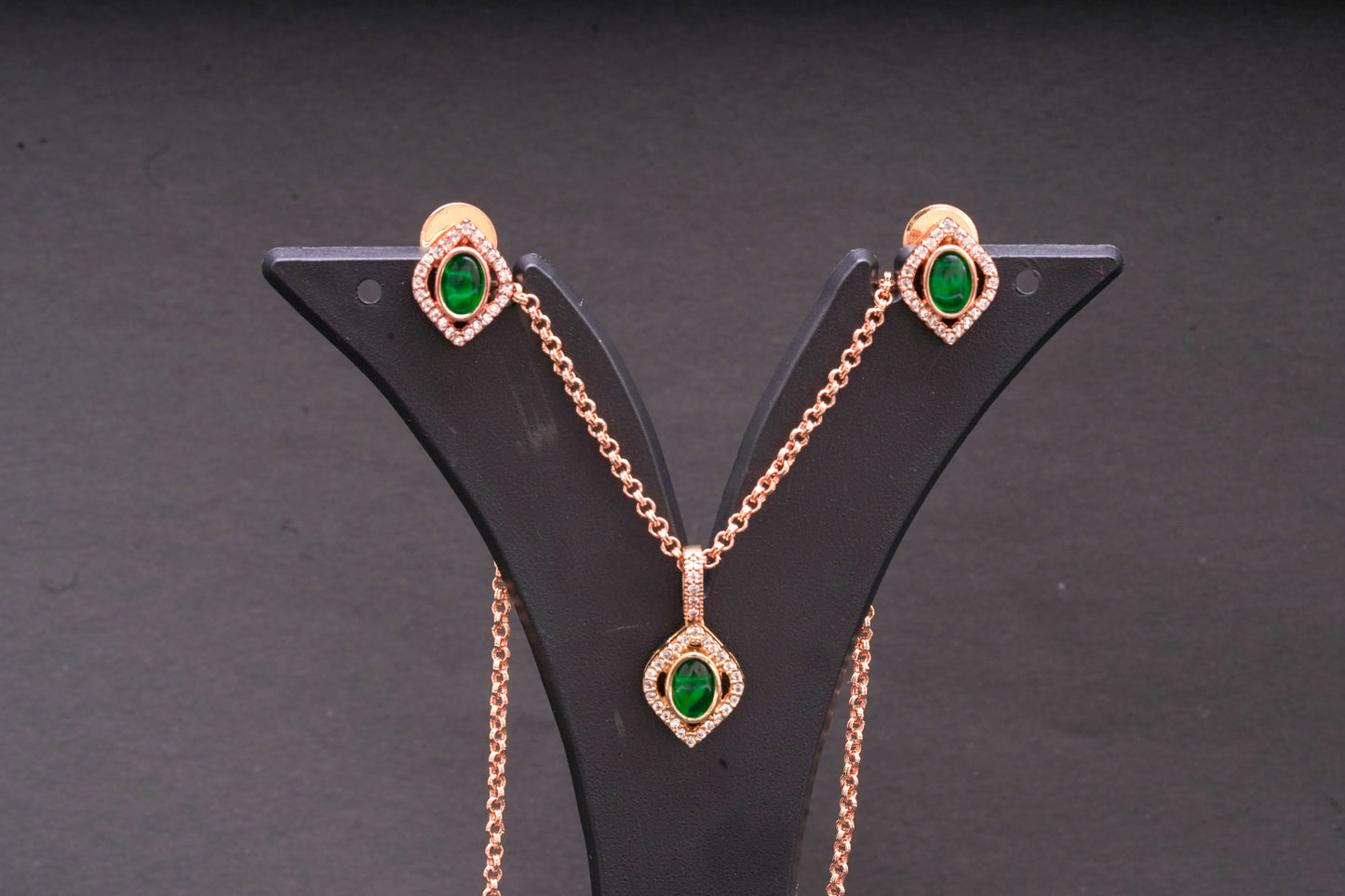 Diamond shaped green stone pendant set in gold finish