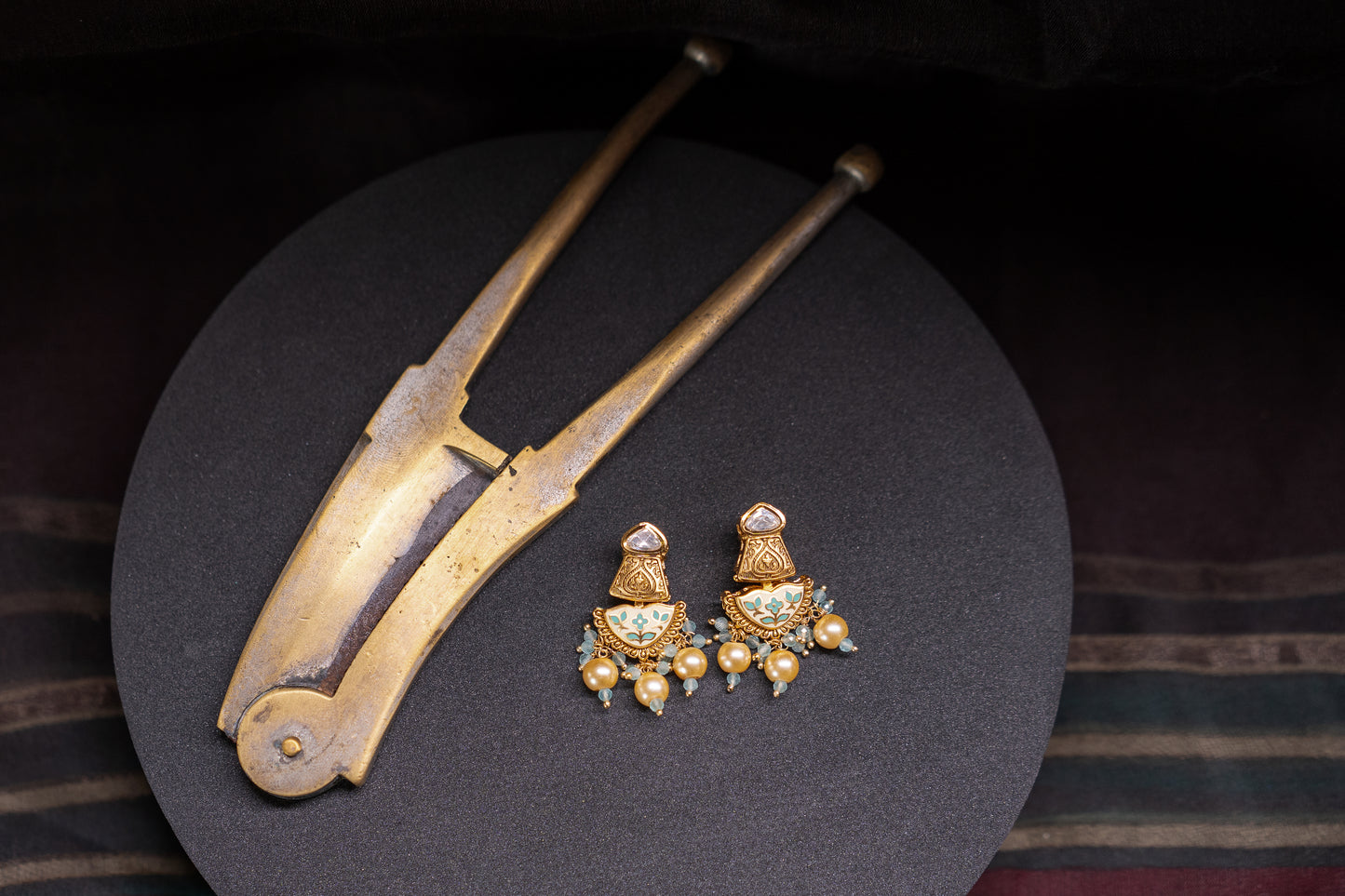 Earrings with white and green enamel work in gold finish