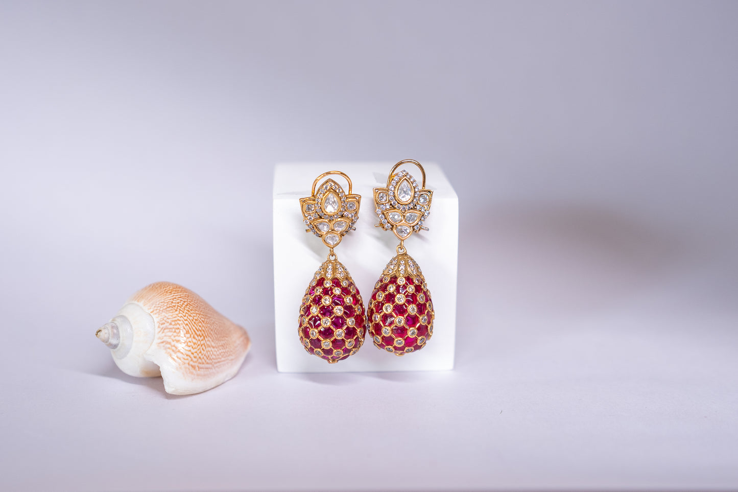 Gold-finish tear drop meenakari earrings in red