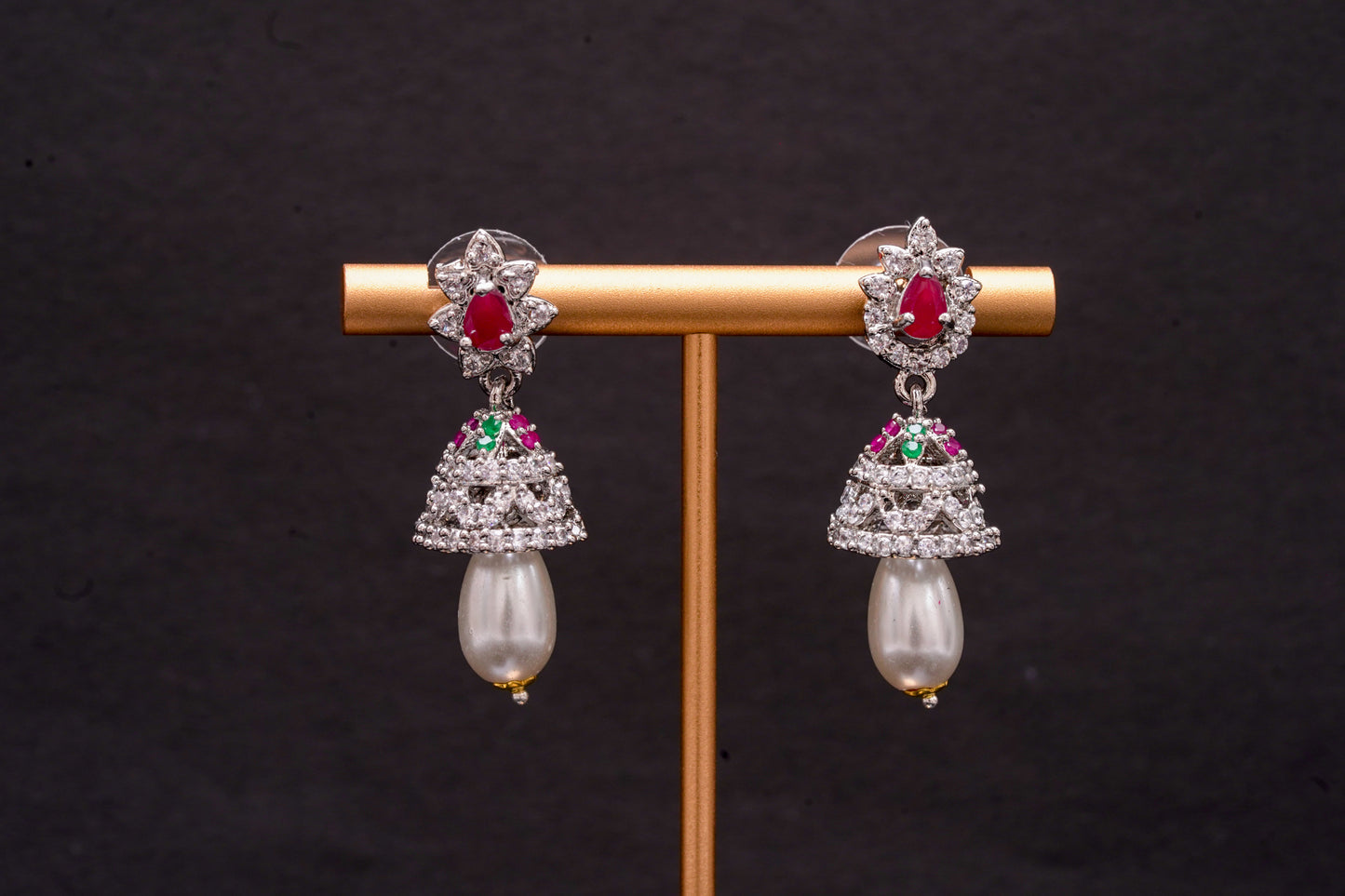 Jhumkas in American diamonds adorned with pearls and red ruby stones