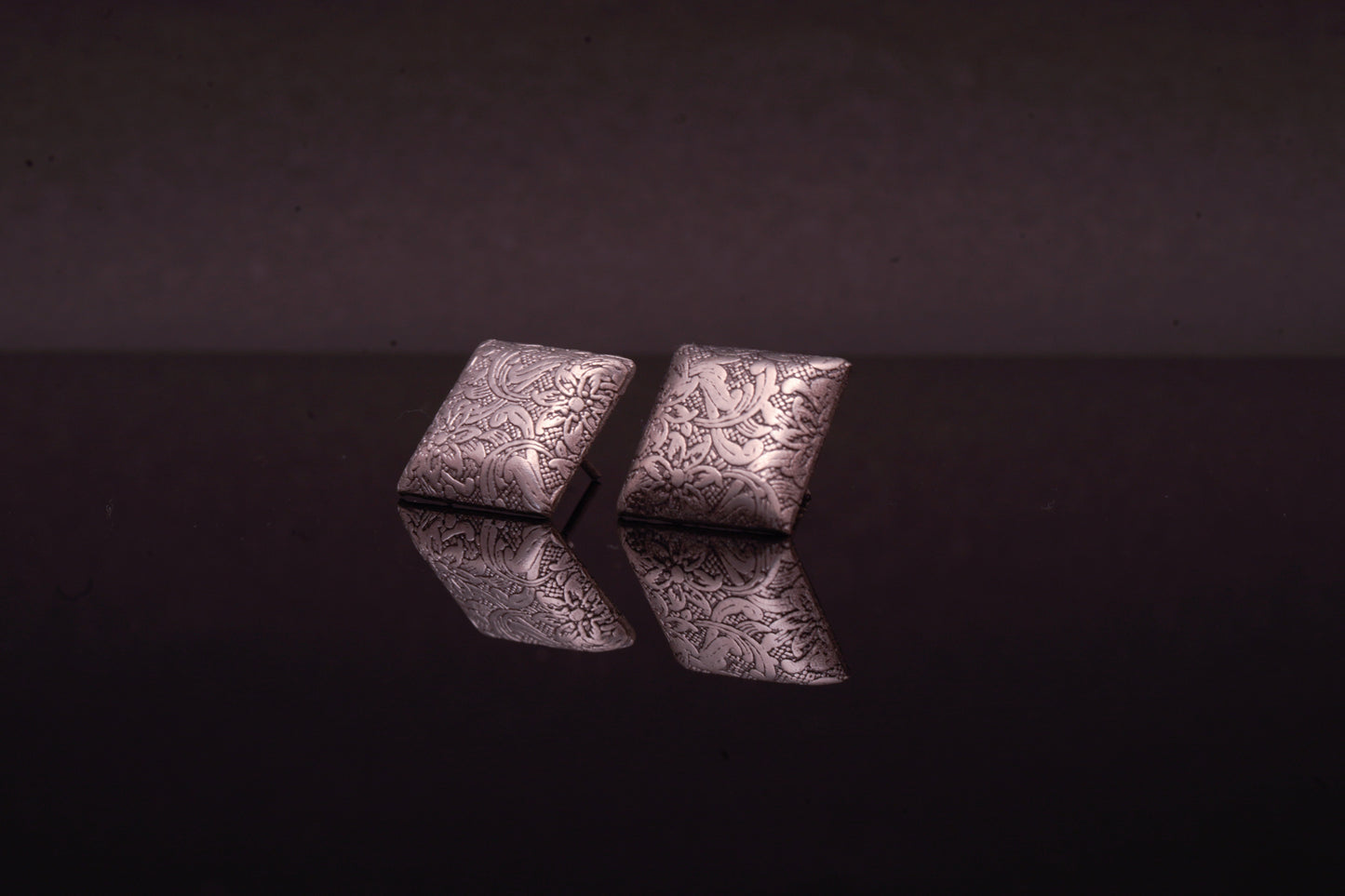 Classic square shaped ear studs with flower carvings in silver finish
