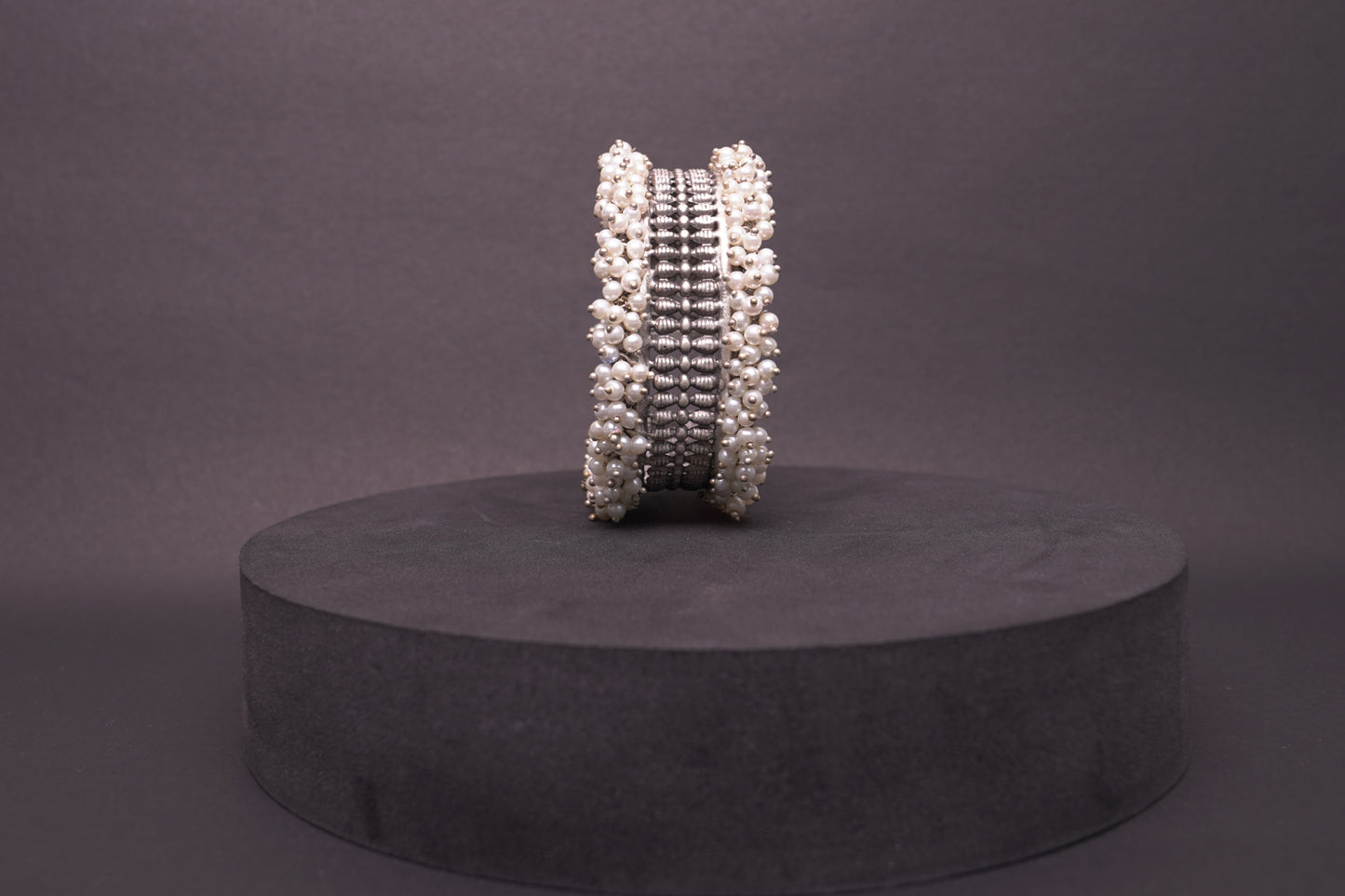 Open, adjustable symmetrical pattern bracelet with dainty pearls