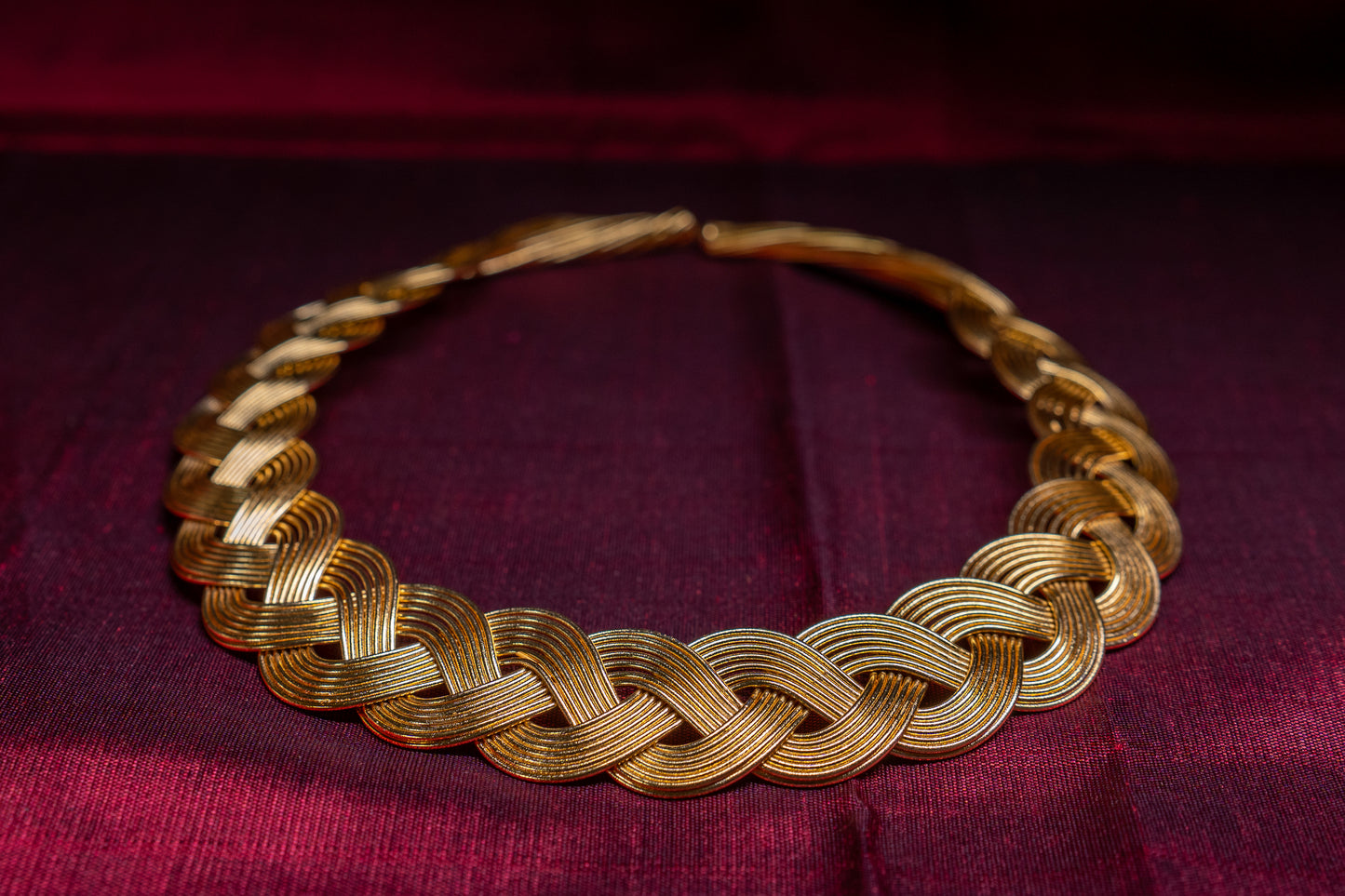 Statement gold finish hasli in an intricate knot pattern