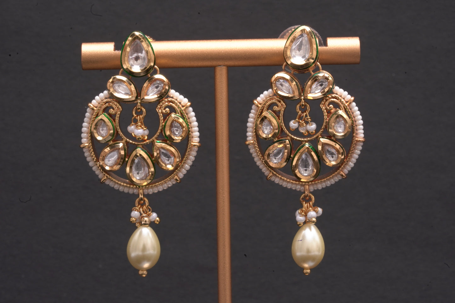 An evergreen chandbali with a single hanging pearl