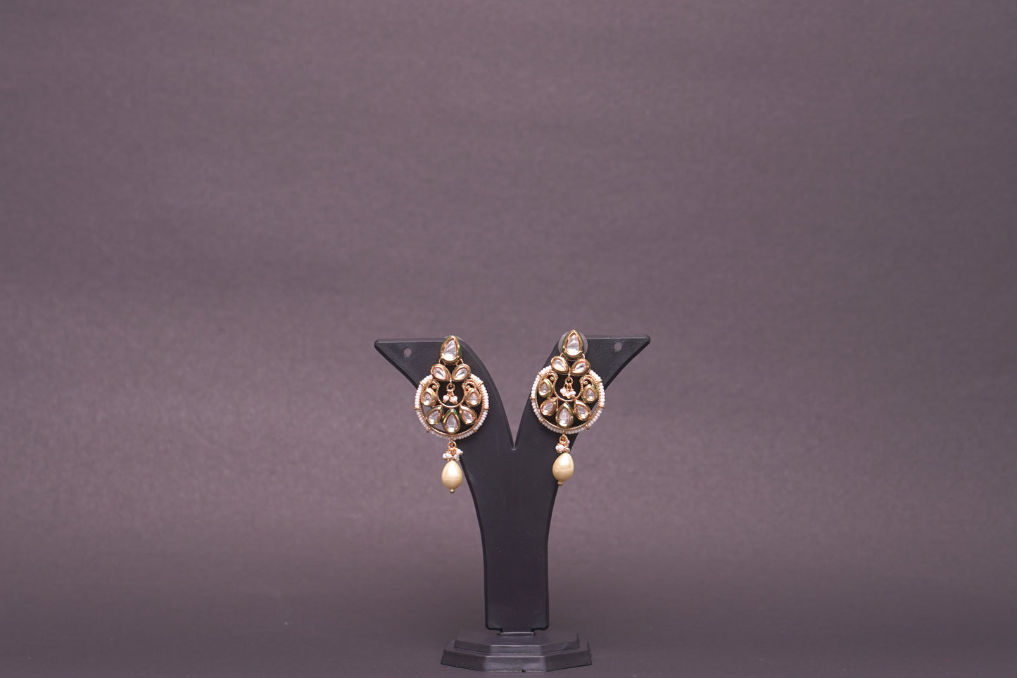 An evergreen chandbali with a single hanging pearl