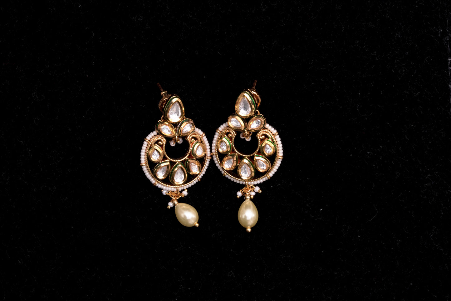 An evergreen chandbali with a single hanging pearl