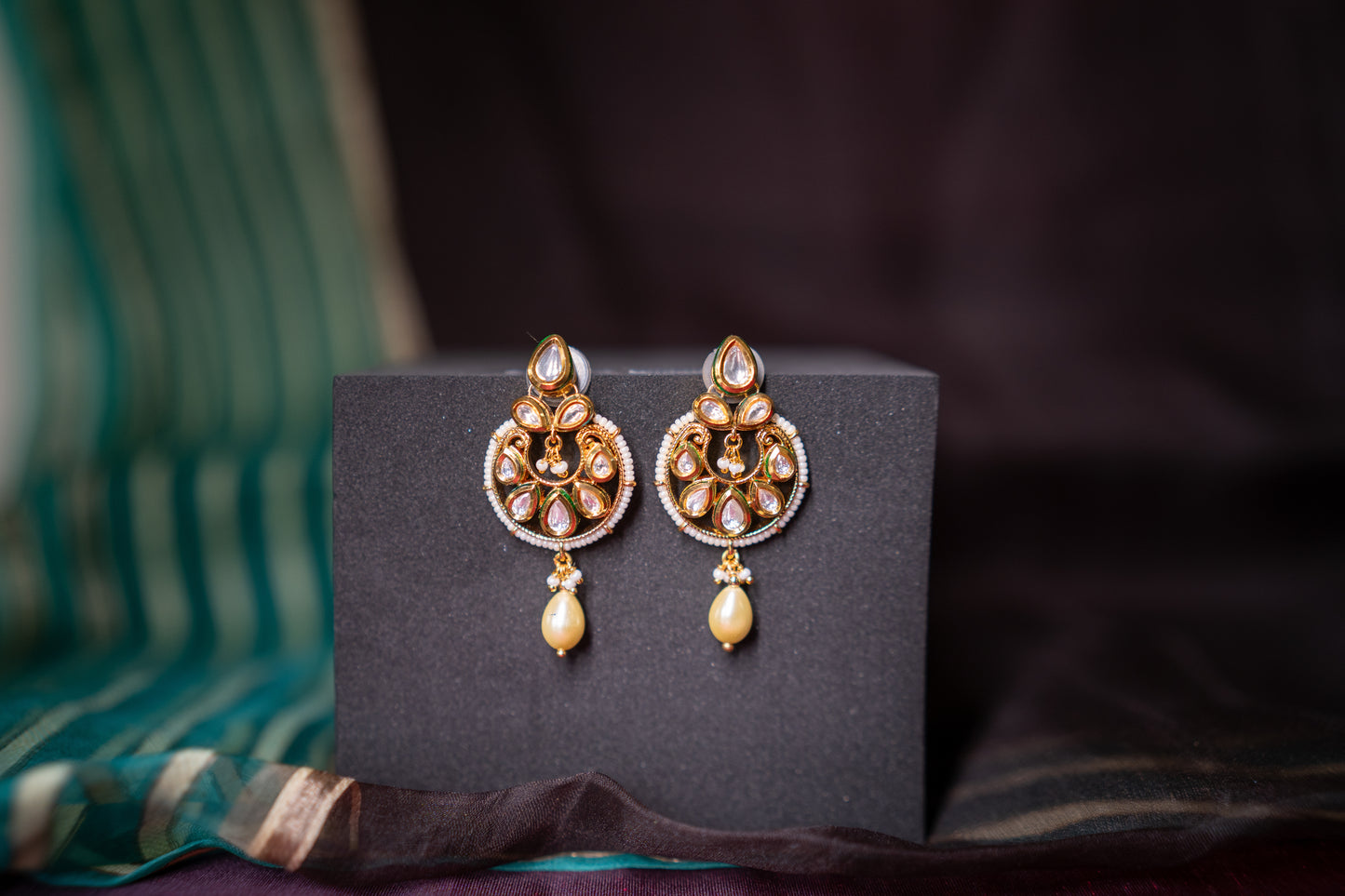 An evergreen chandbali with a single hanging pearl