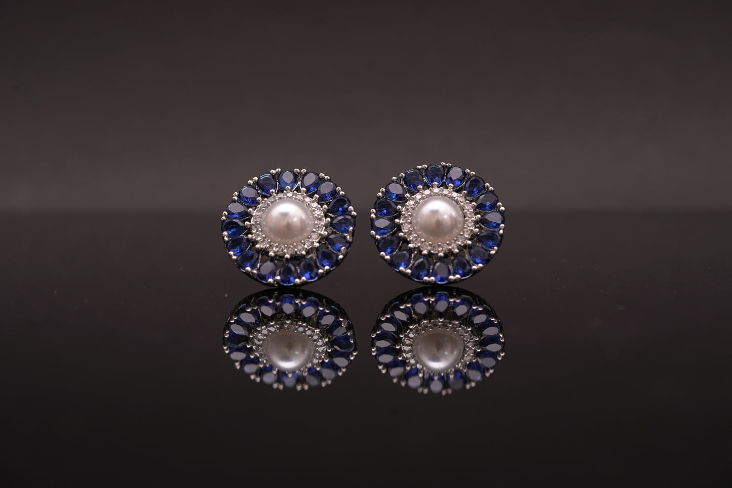 Effortlessly beautiful round ear studs with pearls and blue emerald stones