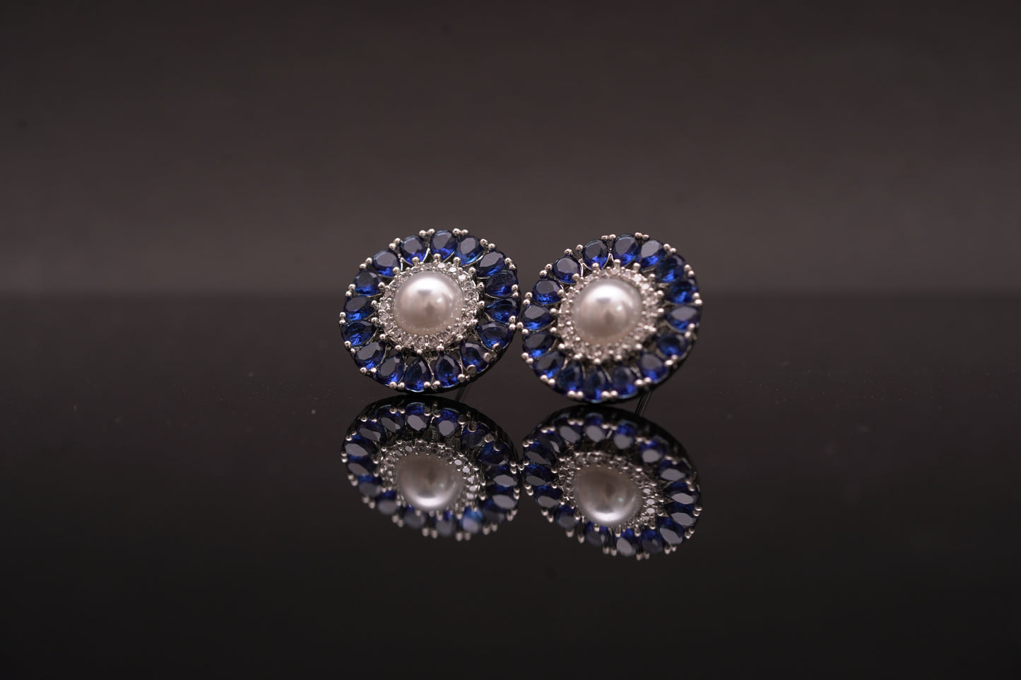 Effortlessly beautiful round ear studs with pearls and blue emerald stones