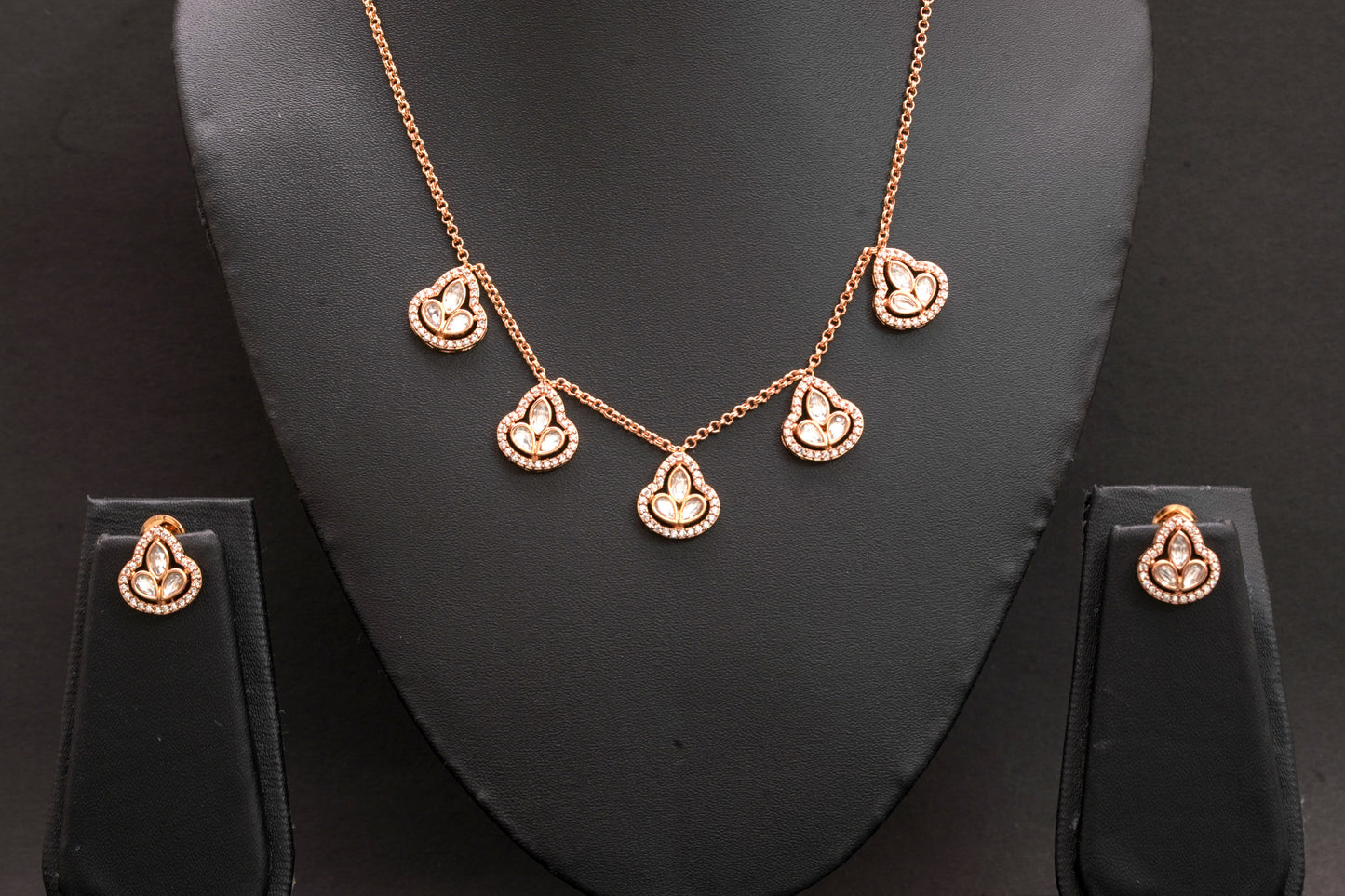 Clover shape pendant set with polki stone and American diamonds in a gold finish