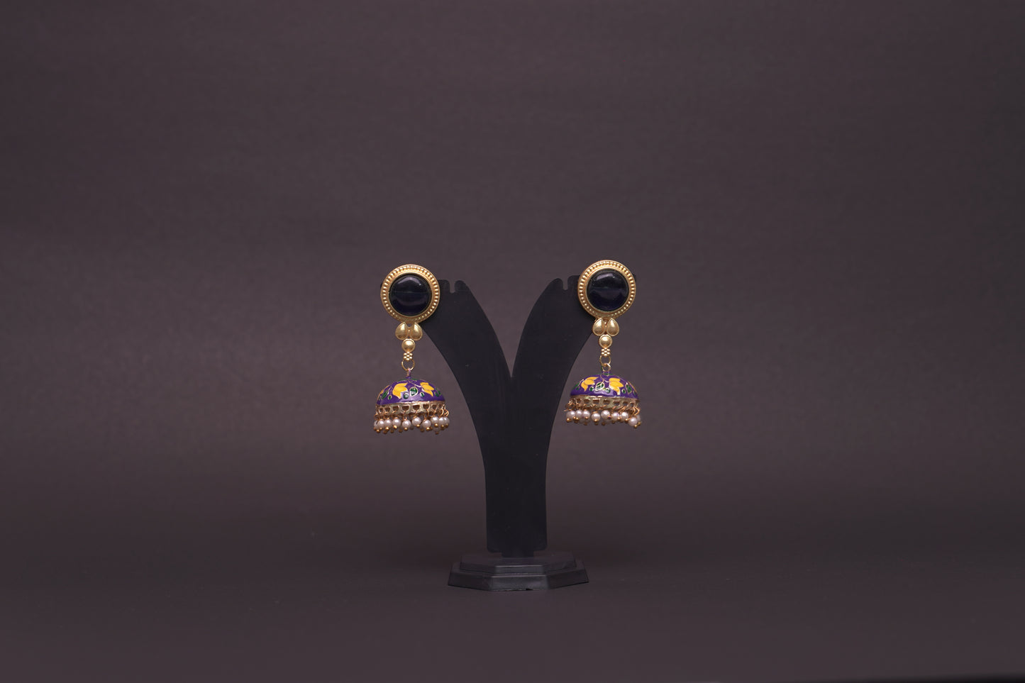 Colourful jhumkas in classic black with purple and white flowers with an enamel finish