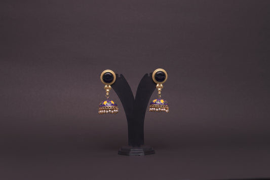 Colourful jhumkas in classic black with purple and white flowers with an enamel finish