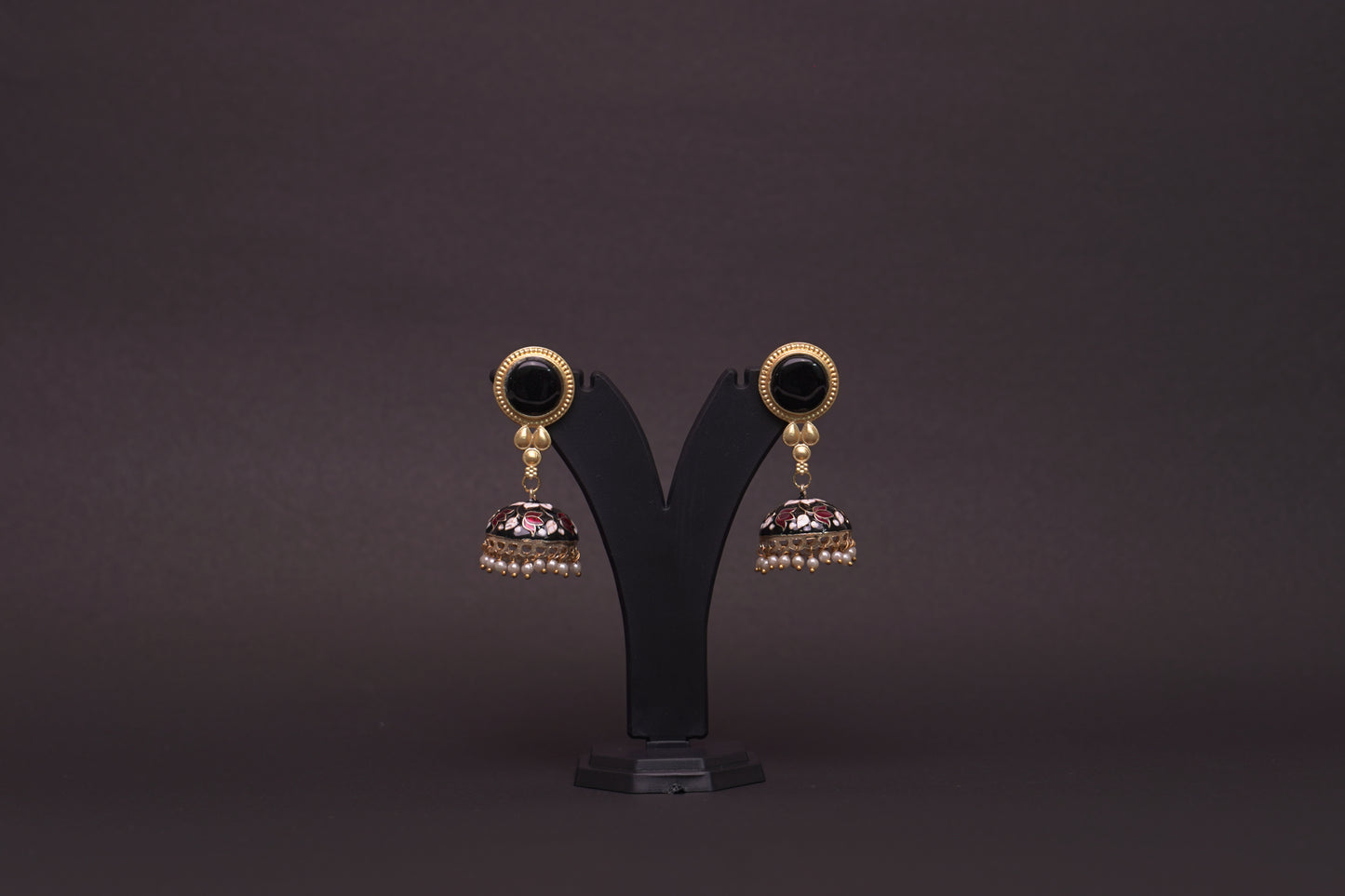 Colourful jhumkas in classic black with white and red flowers with an enamel finish