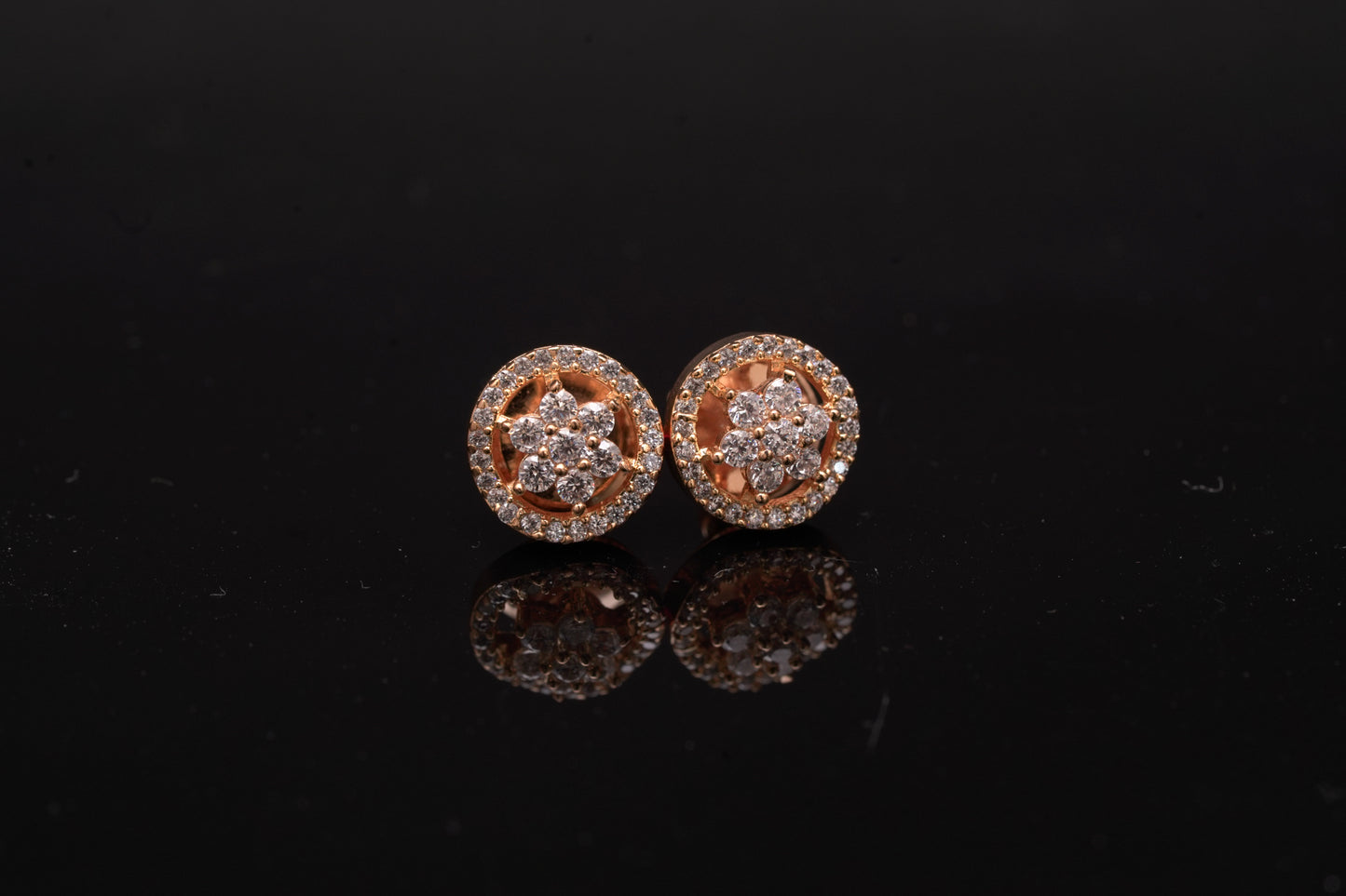 Delicate flower shaped American diamond ear studs in gold finish