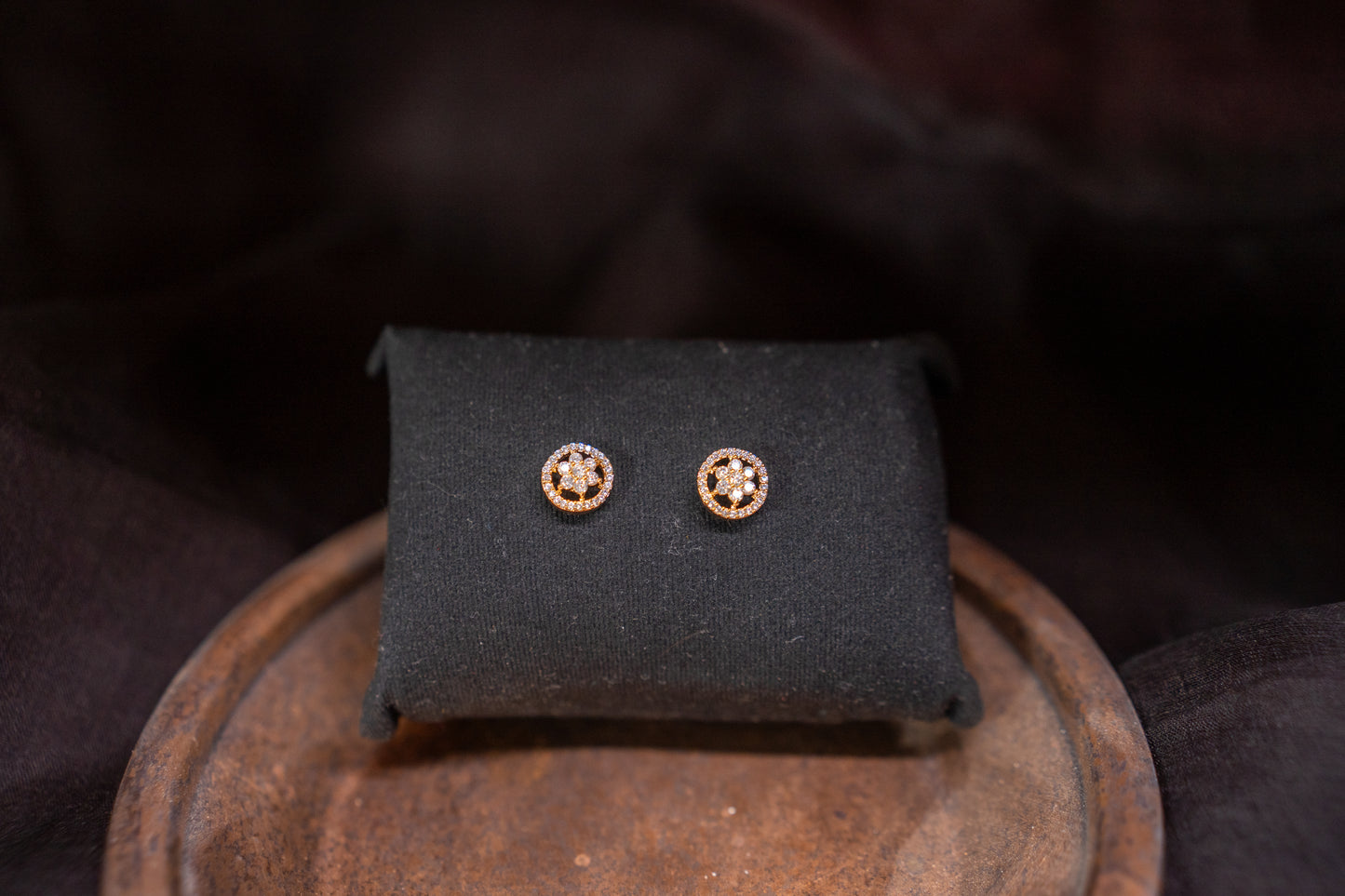 Delicate flower shaped American diamond ear studs in gold finish