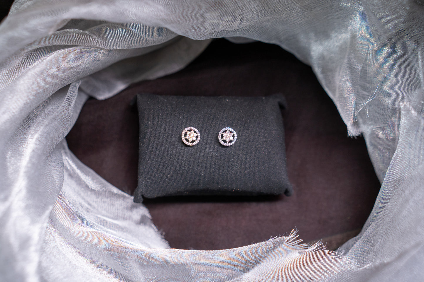 Delicate flower shaped ear studs in American diamonds