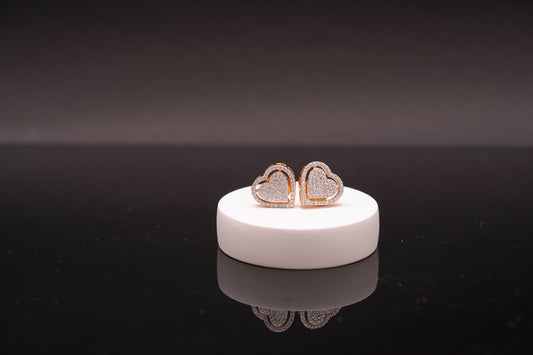 Delicate heart shaped ear studs in American diamond in gold finish