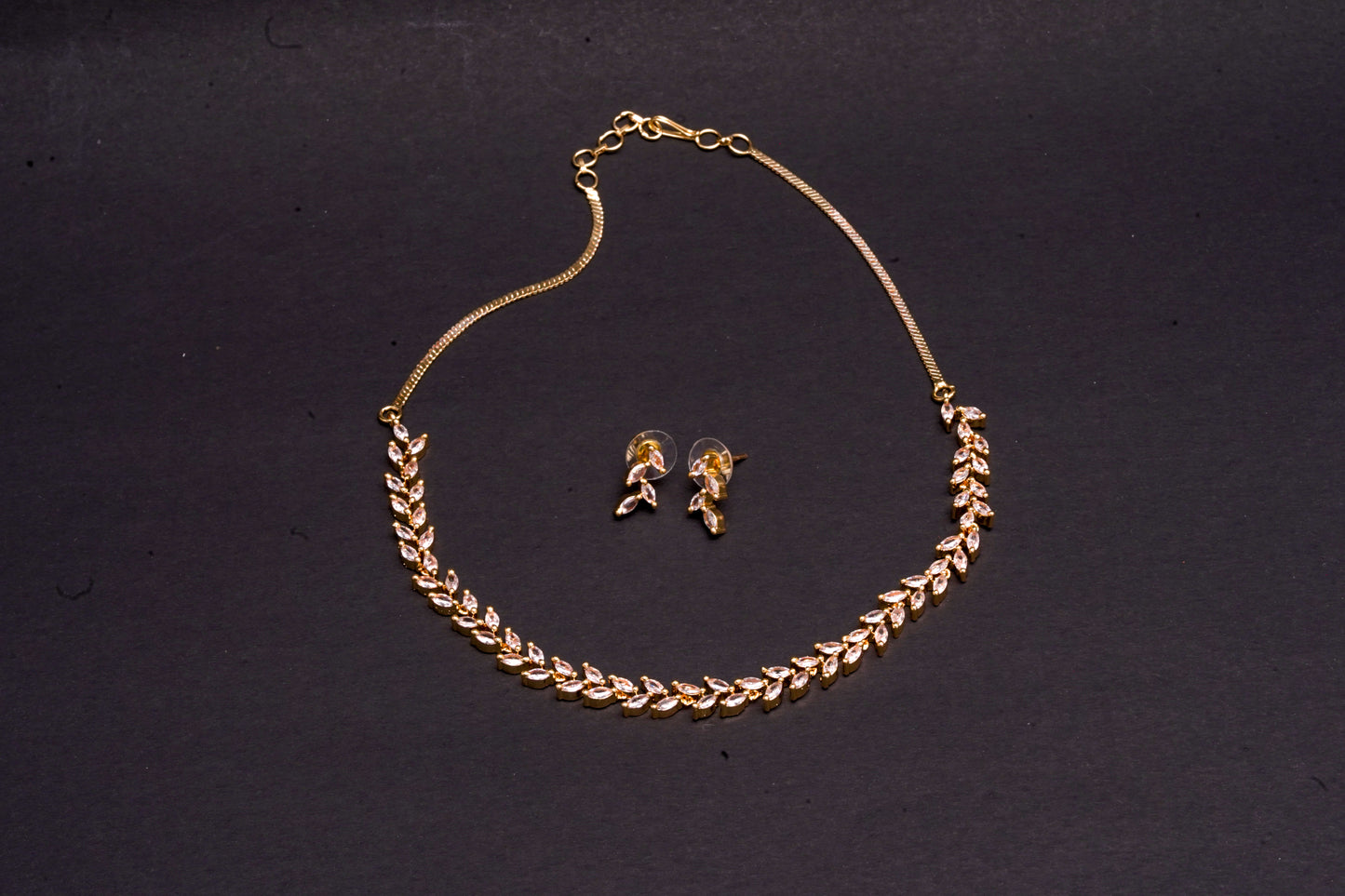 Delicate leaf motif necklace set in real American diamonds with gold finish