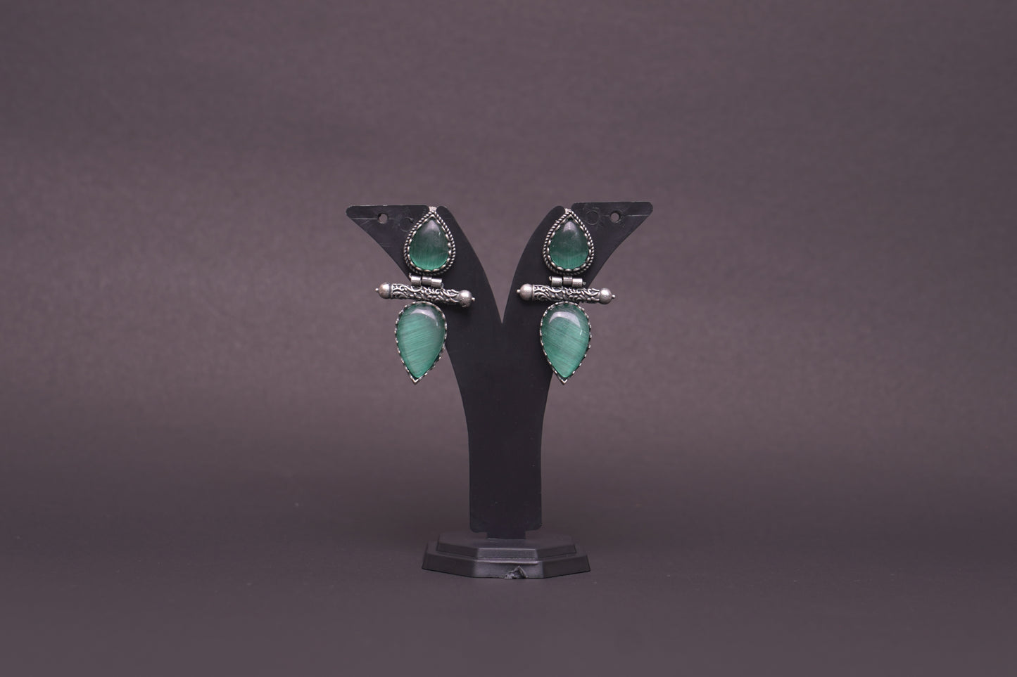 Dual tear drop earrings with sea green stone in silver finish