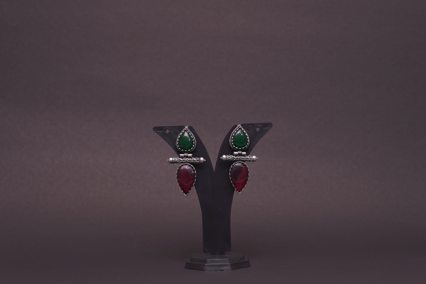 Dual tear drop earrings with red and green stone in silver finish