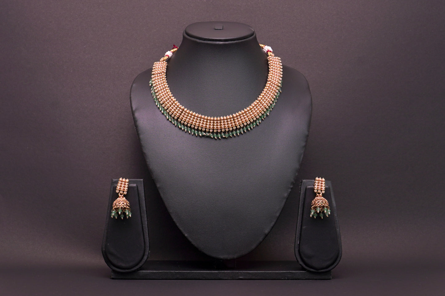 Interlink necklace with unique jhumkas in a gold finish