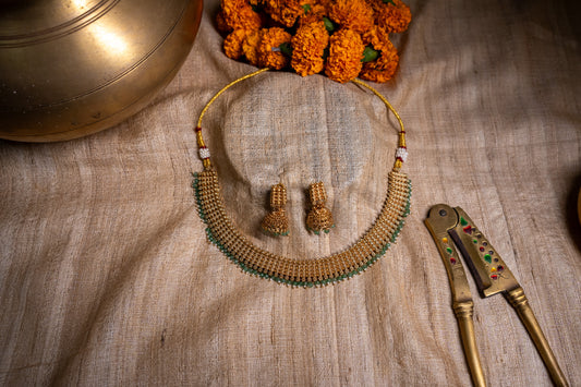 Interlink necklace with unique jhumkas in a gold finish