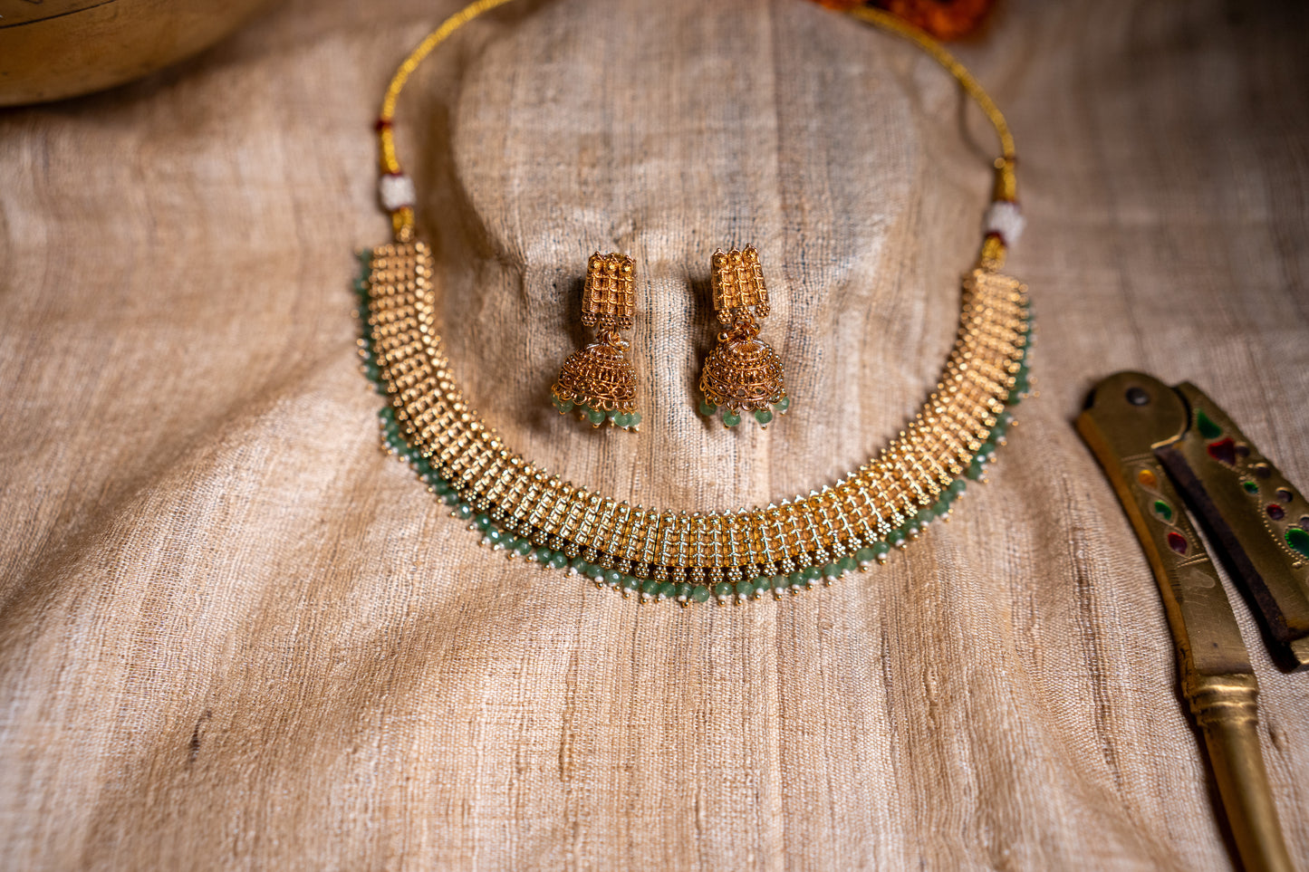 Interlink necklace with unique jhumkas in a gold finish