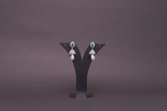 Jhumkas in American diamond adorned with pearls and green, emerald stones
