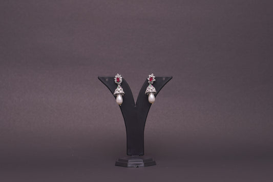 Jhumkas in American diamonds adorned with pearls and red ruby stones