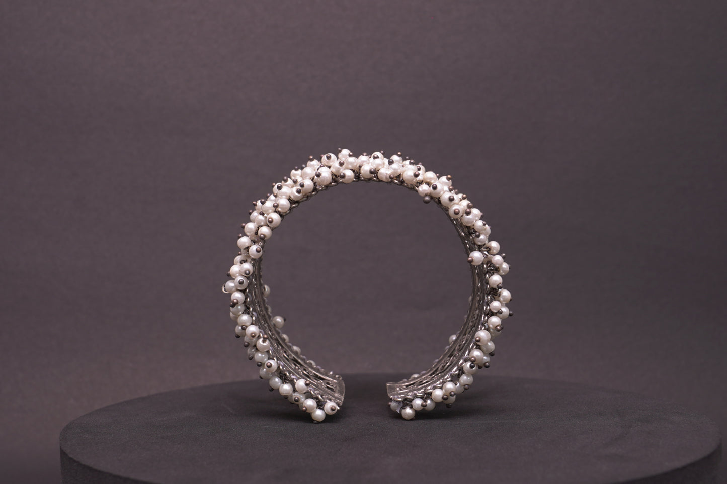 Open, adjustable flower pattern bracelet with dainty pearls