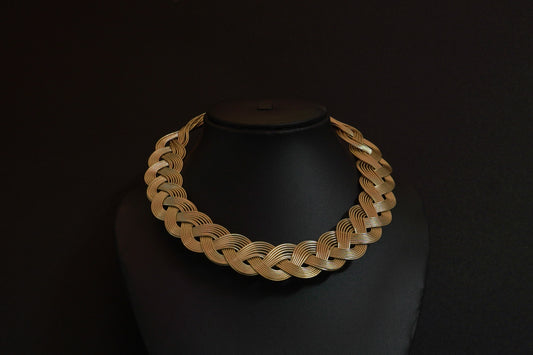 Statement gold finish hasli in an intricate knot pattern