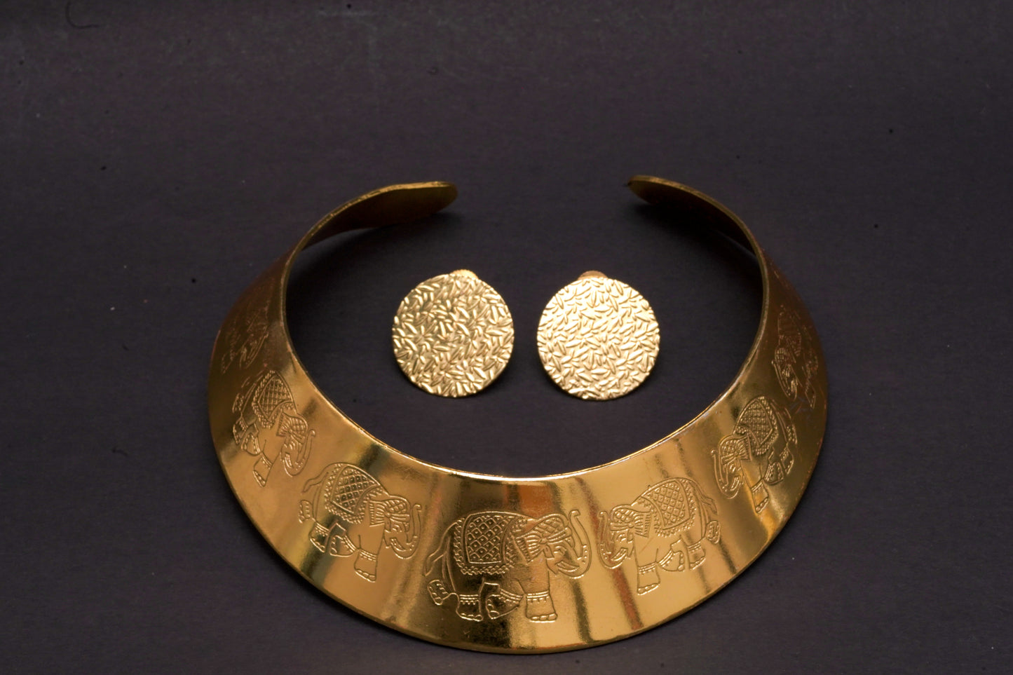 Statement gold finish hasli with elephant motifs and ear studs