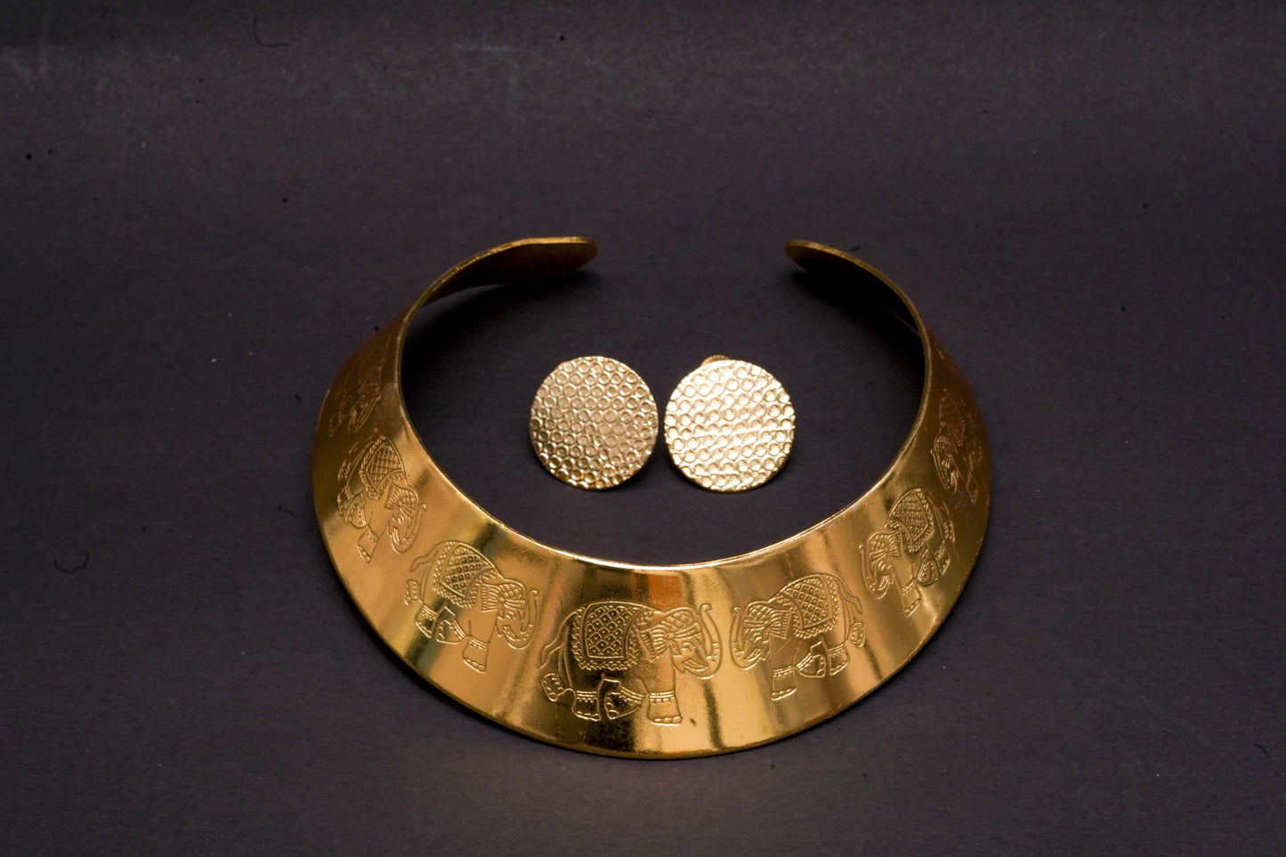 Statement gold finish hasli with elephant motifs and ear studs