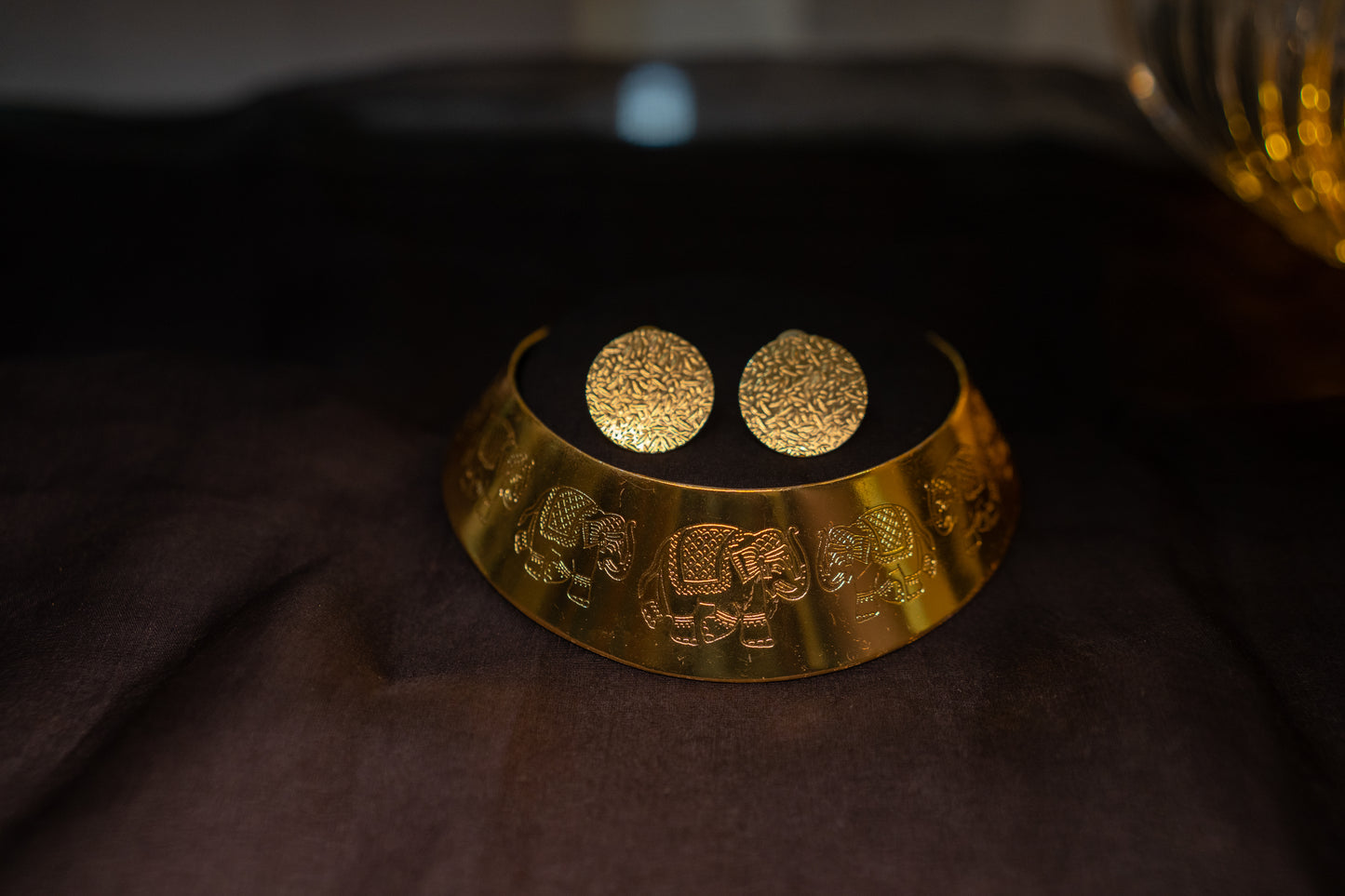 Statement gold finish hasli with elephant motifs and ear studs